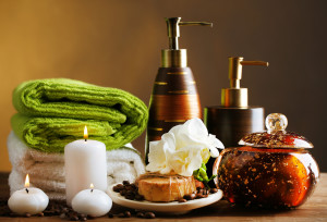 Composition of spa treatment on wooden table, on dark color background